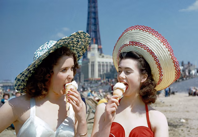 Two girls enjoy ice creams on the sands at Blackpool, July 1954. Blackpool Tower can be seen in the background. Original publication: Picture Post - 7227 - Blackpool - pub. 31st July 1954 (Photo by John Chillingworth/Picture Post/Hulton Archive/Getty Images)